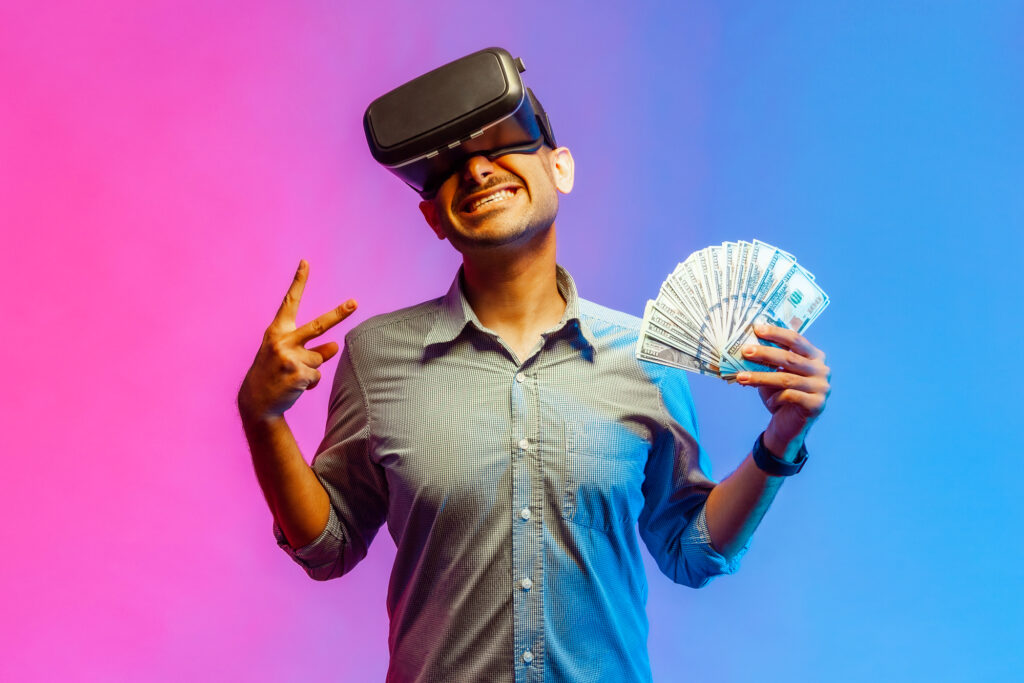 A man immersed in virtual reality, wearing a headset, surrounded by vibrant colors and grasping money in one hand.