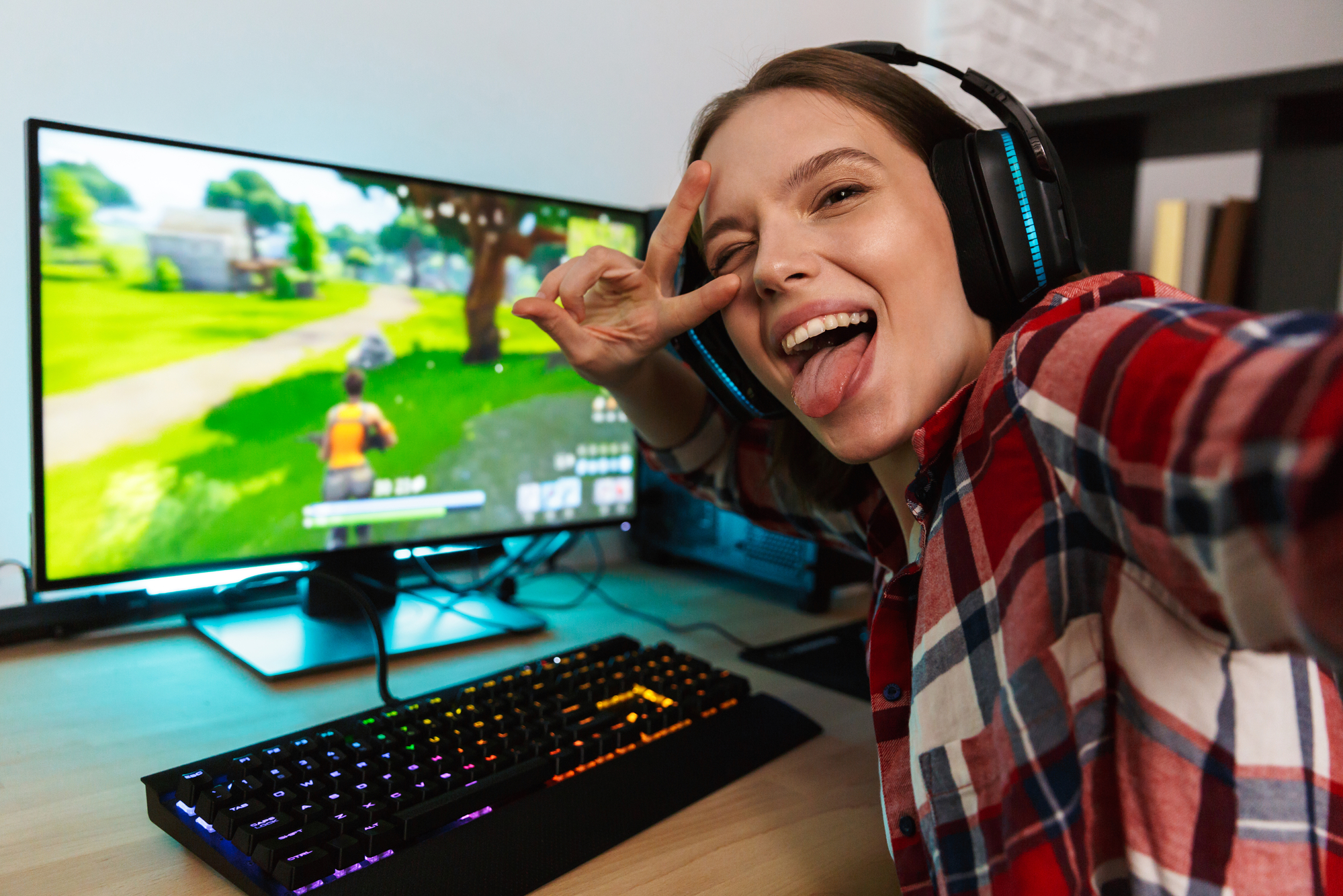 A girl is getting paid to play Fortnite on a computer.