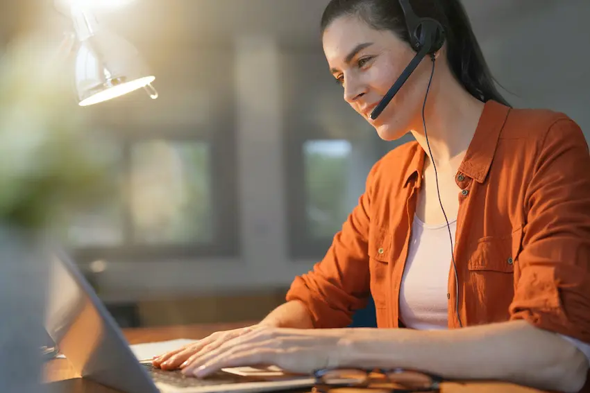 a woman wearing a headset doing a customer service job to make extra cash