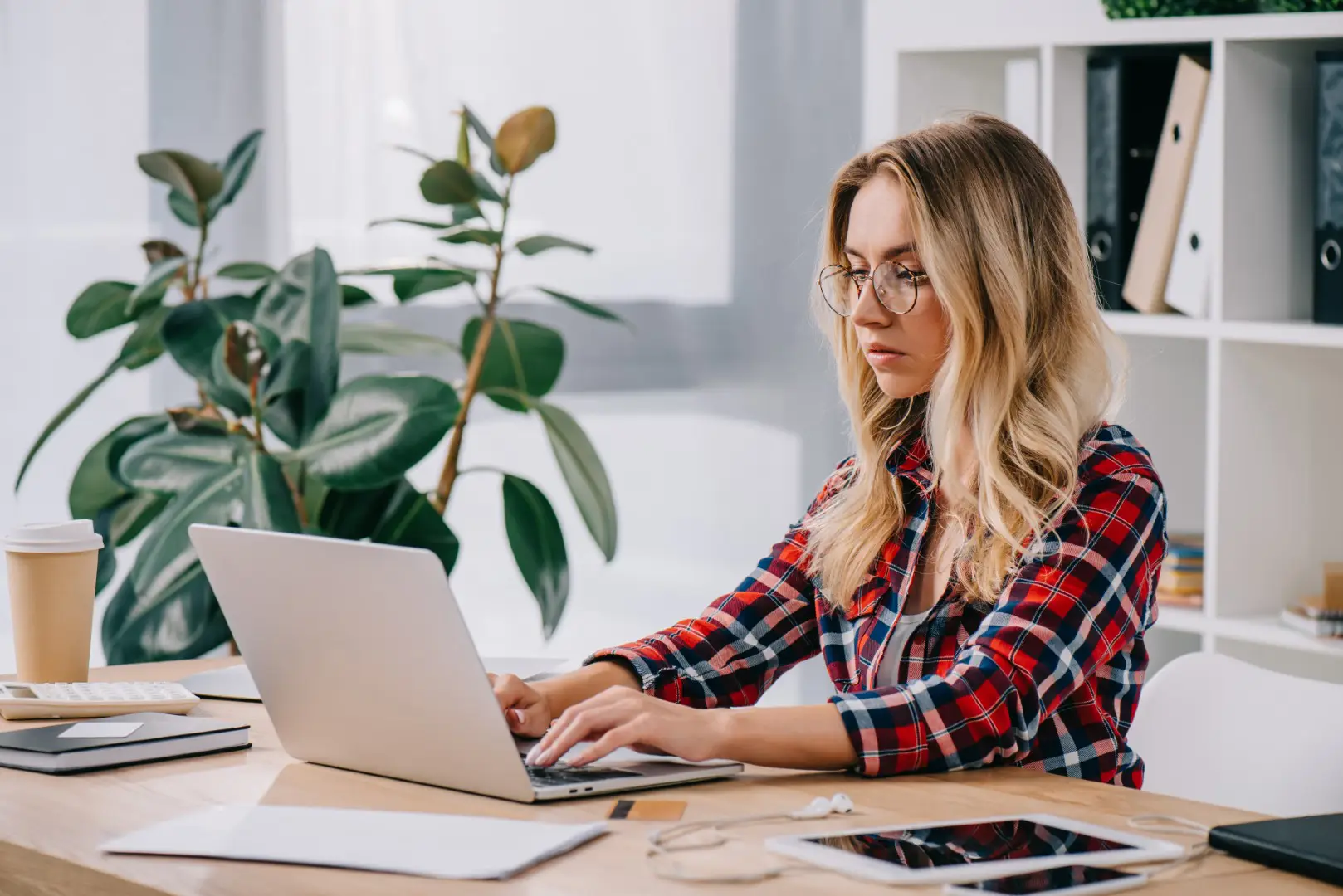 how to earn extra money in the UK - a woman works at her laptop