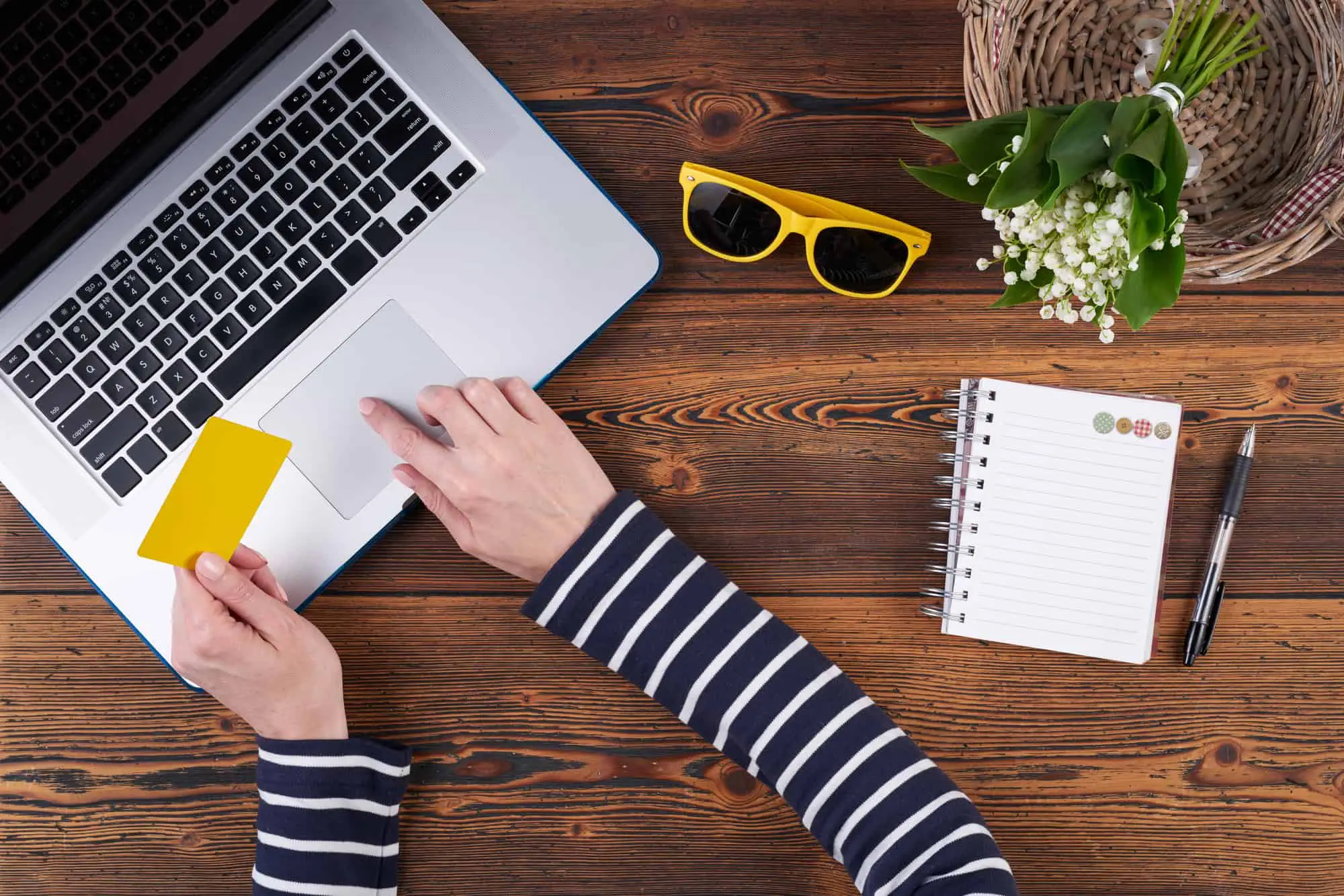 woman with credit card and laptop at desk