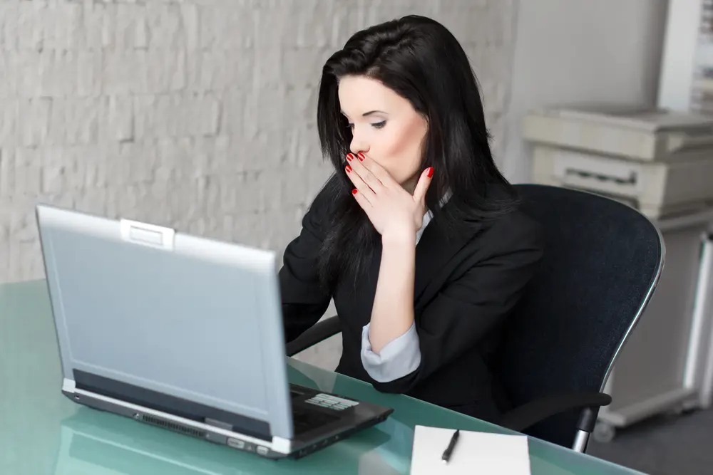 woman in black doing flirt chat on her laptop