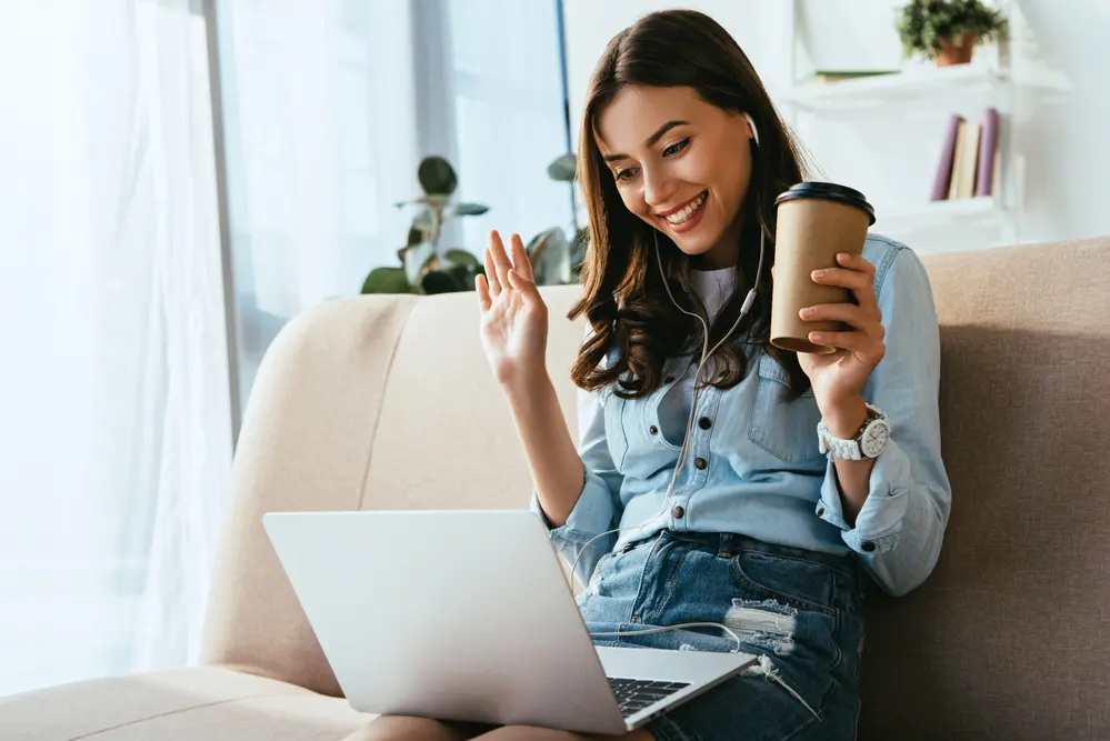 a woman chatting online holding a coffee