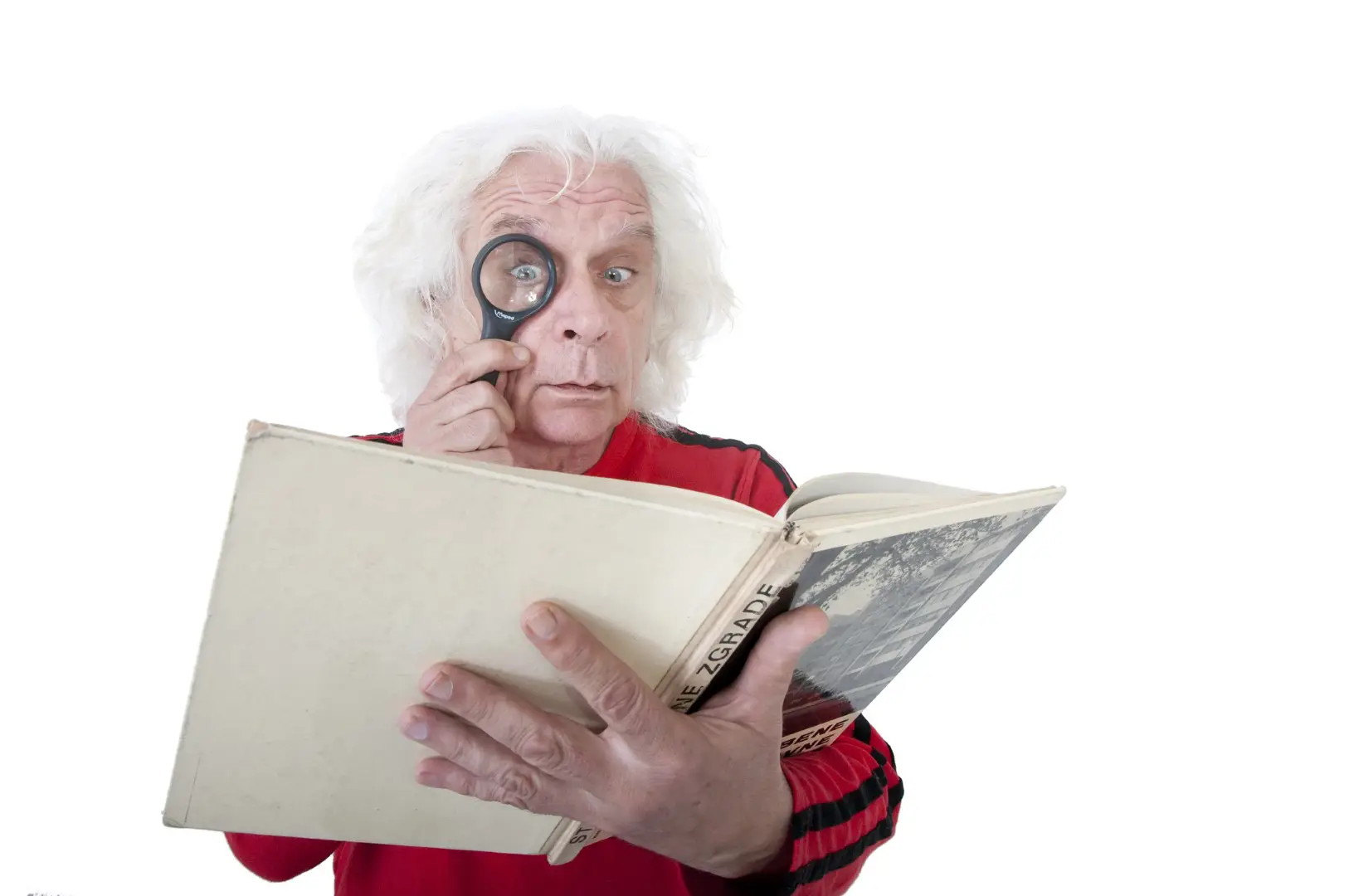 a man reading a book with a magnifying glass