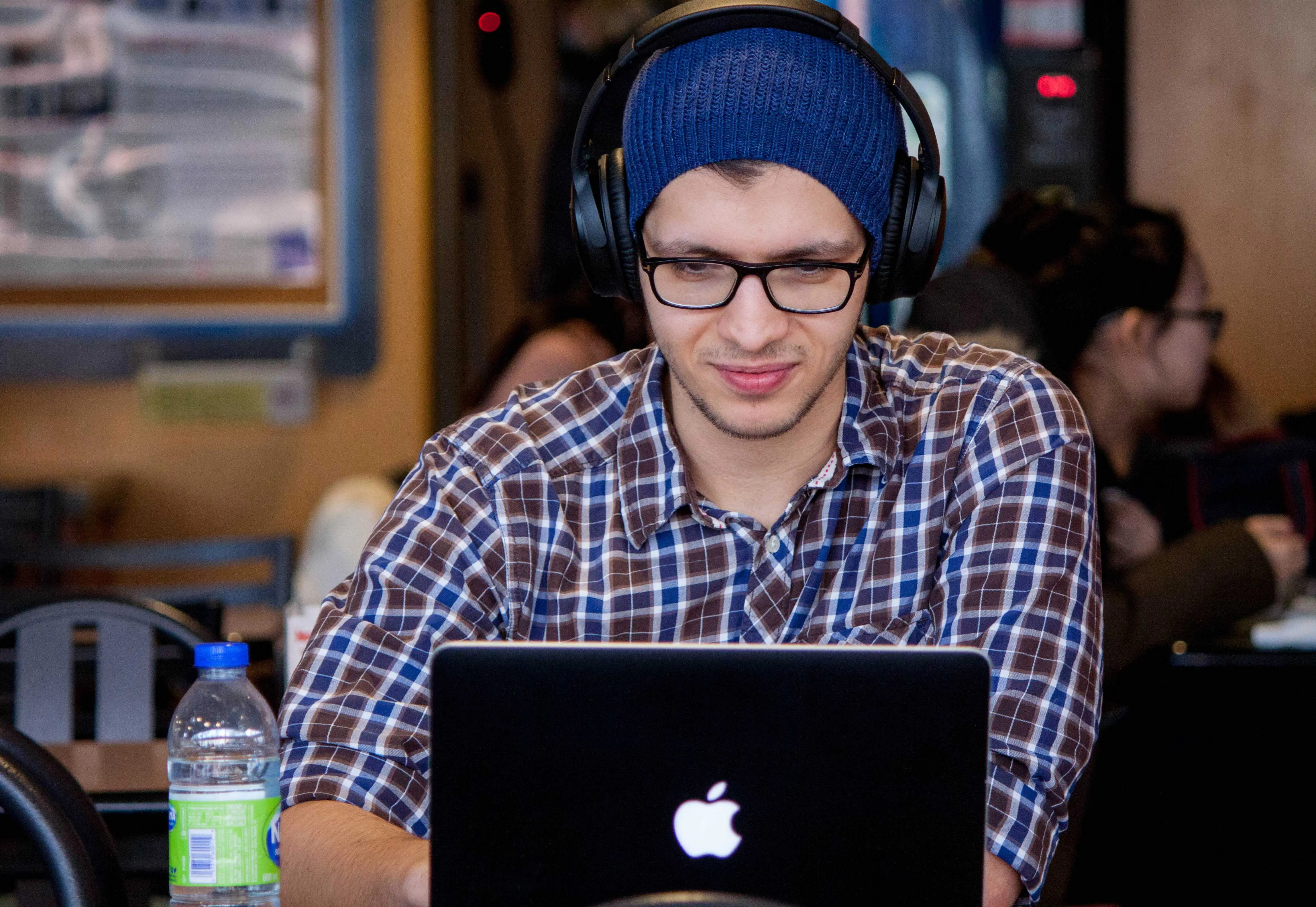 male student studying at his laptop. Find out how to study online for a free degree course!