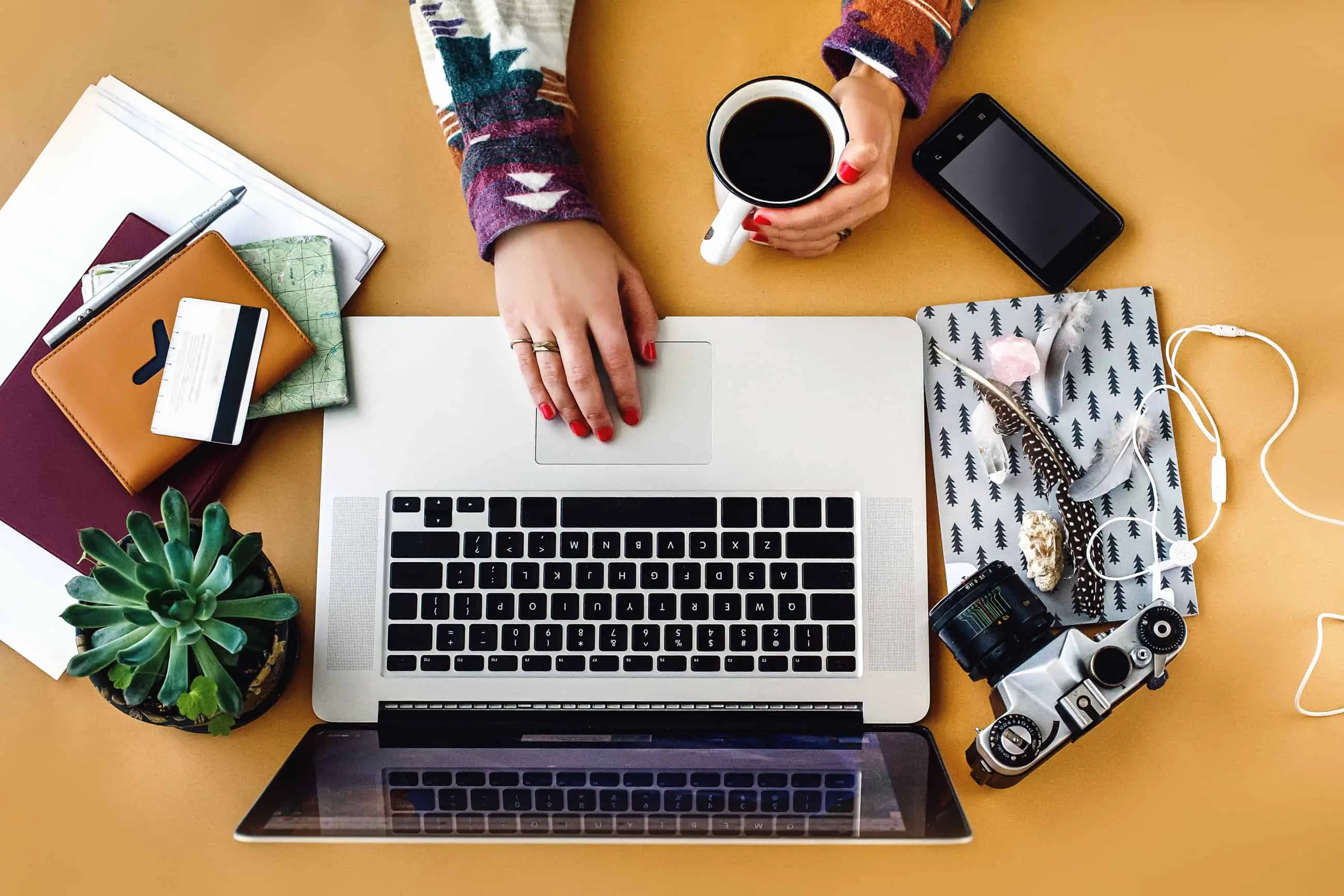 A blogger working at their laptop with a cup of coffee