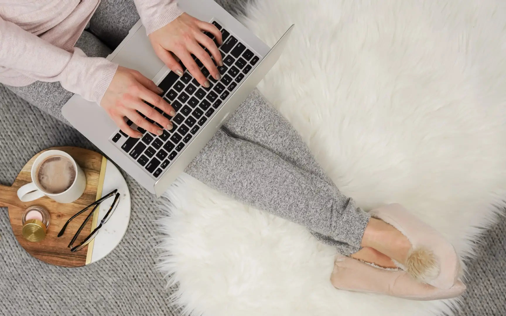 a blogger working on her laptop with tea