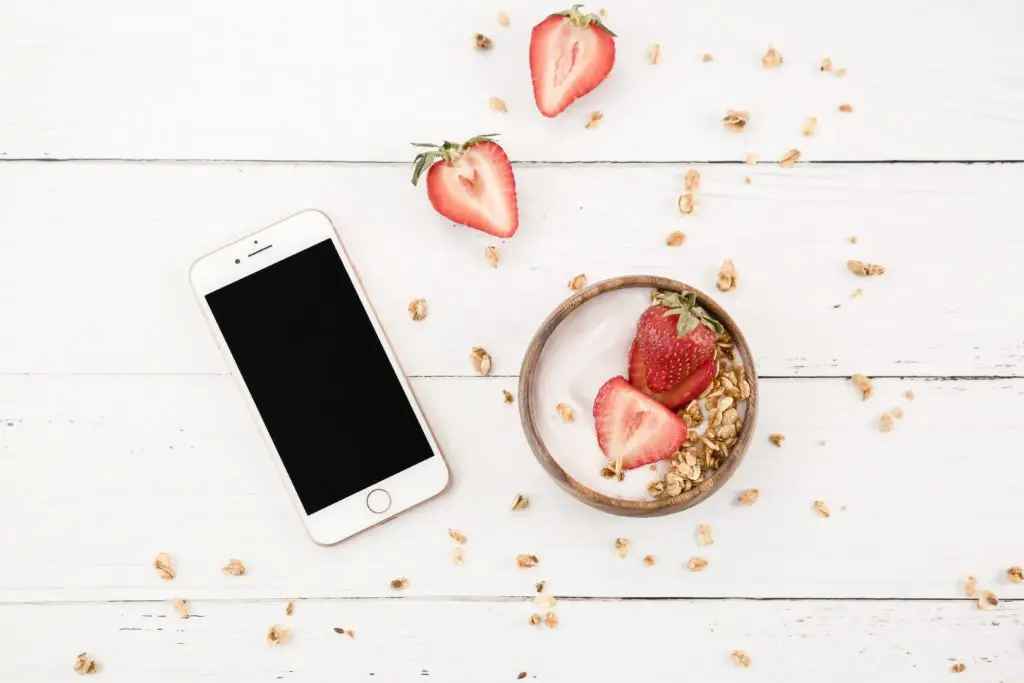 phone and strawberries on desk