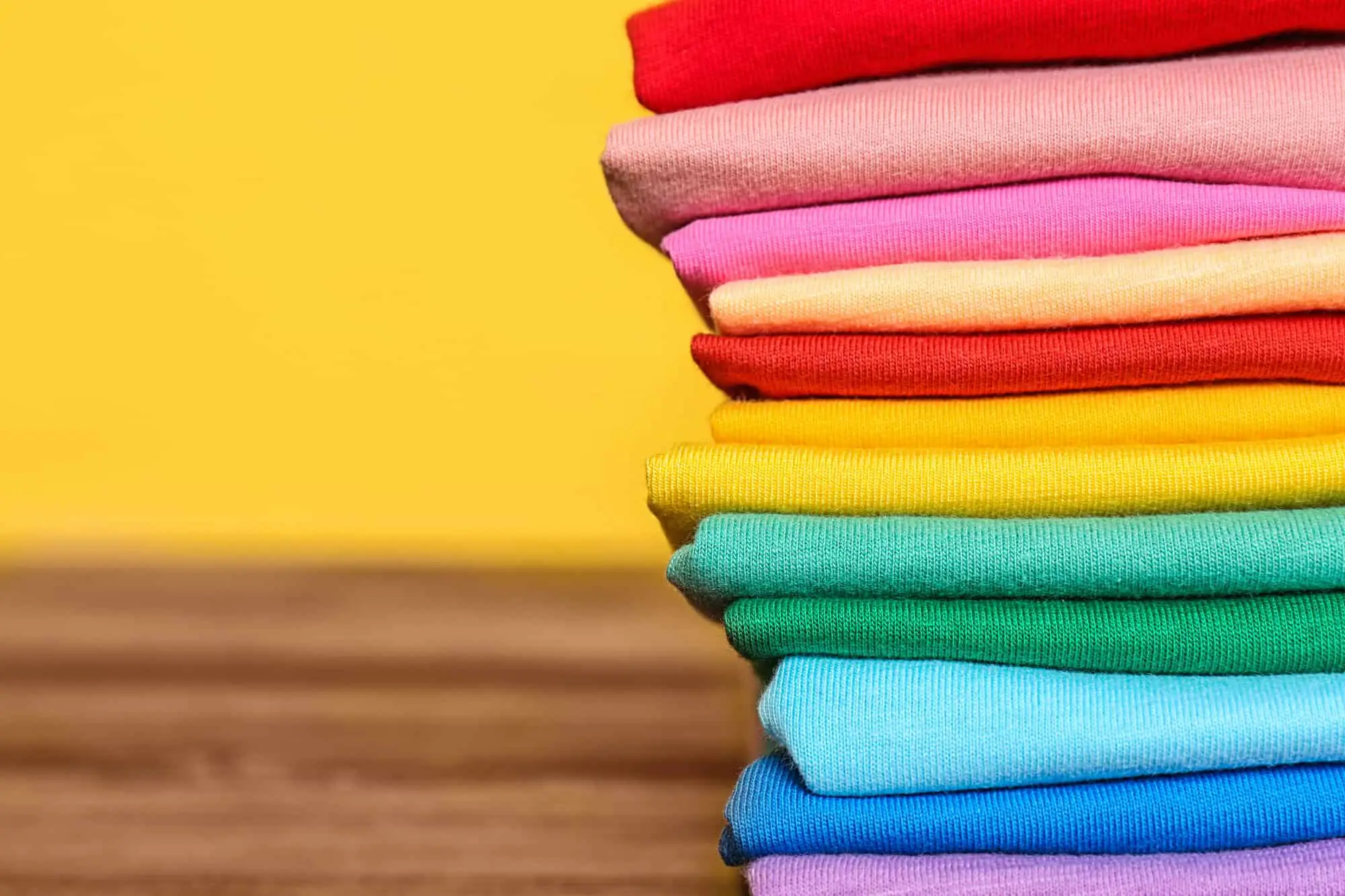 Stack of colorful t-shirts - make money selling t shirts online on Amazon